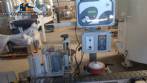 Automatic self-adhesive labeling machine for cylindrical bottles