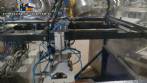Pick and place product feeder for flowpack transfer cartoning machine
