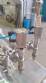 Filling machine with 2 nozzles for liquids and pilfer cap screwer