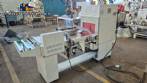 L-shaped packaging sealer with semi-automatic shrink tunnel.