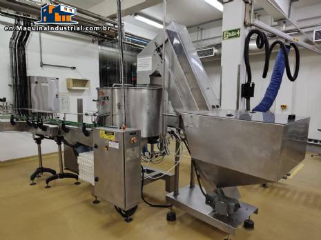 Complete bottling line with filling, labeling, capping, cap positioning and bottle elevator machine by Nelpas Fujinox.