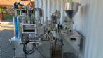 Delgo rotary bottle and jar filling machine for pasty, sweet, and dairy products.
