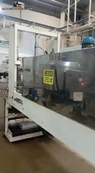 Labeling machine with steam sleeve tunnel and bottle baler