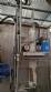 Labeling machine with steam sleeve tunnel and bottle baler