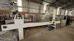 Labeling machine with steam sleeve tunnel and bottle baler