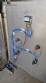 Labeling machine with steam sleeve tunnel and bottle baler