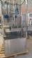 Labeling machine with steam sleeve tunnel and bottle baler
