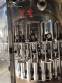 Zegla rotary filling machine with rinser and three-block capping system.