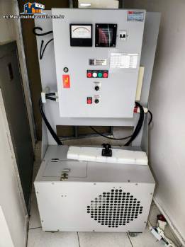 Automatic stainless steel induction lid sealer for GRC jars and bottles.